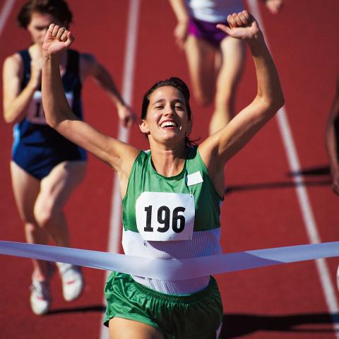 Female Athlete on a Race Track Winning the Race