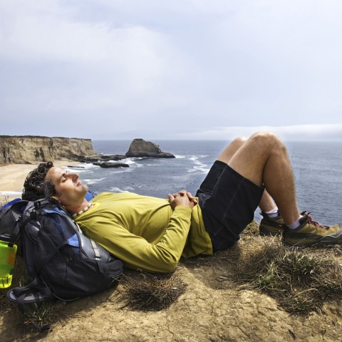 A Man Resting in Nature After a Hike