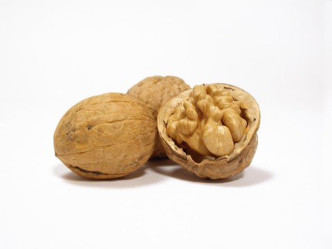 Three Walnuts, with One of Them Broken Open