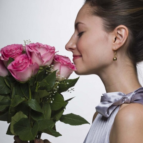 Woman Smelling a Bouquet of Flowers