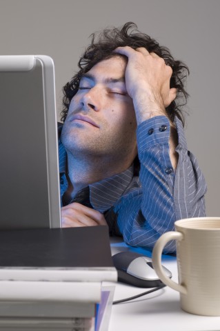 A Man Falling Asleep at His Computer
