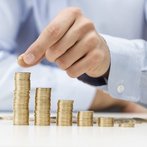 Someone Counting Stacks of Coins