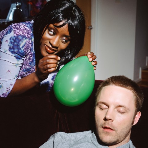 A Woman about to Pop a Balloon in a Sleeping Man’s Face