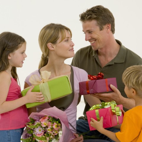 Husband and Children Giving a Mother Gifts on Mother’s Day