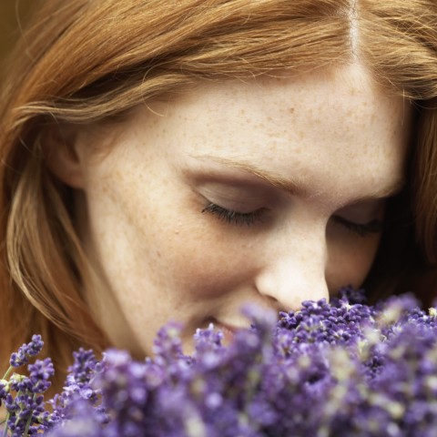 A Woman Smelling Flowers