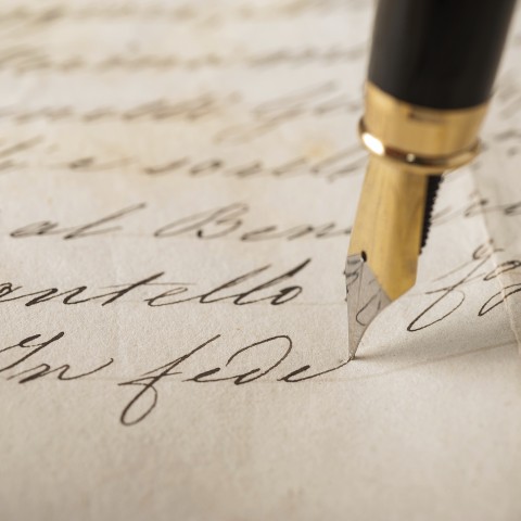 Someone Writing in Cursive Using a Fountain Pen