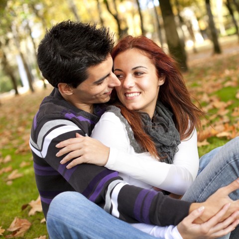 A Boyfriend Holding His Girlfriend in a Park During Autumn