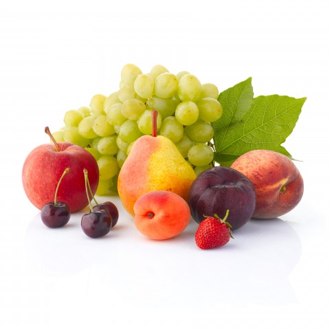 A Variety of Fruits and Berries Against a White Background