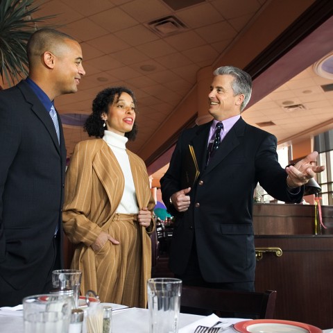 A Waiter in a Nice Restaurant Seating a Couple