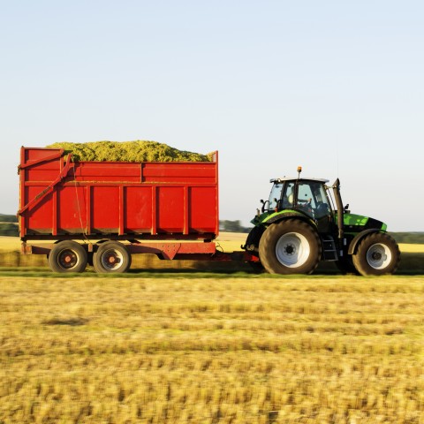 A tractor Pulling a Lot of Wheat