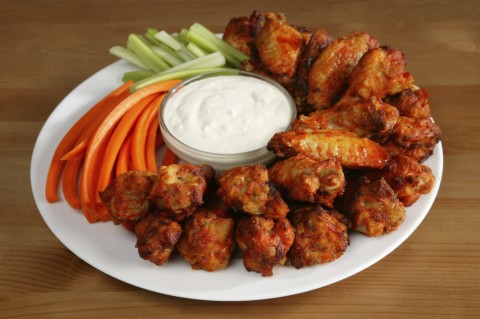 A Plate of Chicken Wings, Carrots, Celery, and Dipping Sauce - Typical Food for Super Bowl Sunday