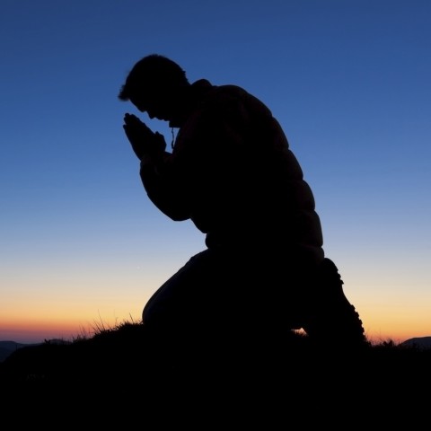 a silhouette of someone praying in repentance