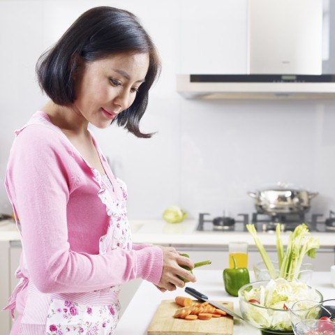 A Woman Chopping Veggies