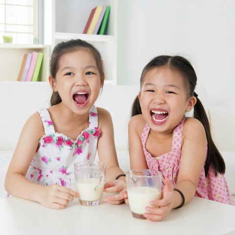 Two Little Girls Drinking Milk