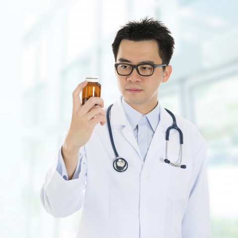 A Doctor Examining a Pill Bottle