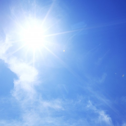 The Sun Shining Brightly in a Blue Sky