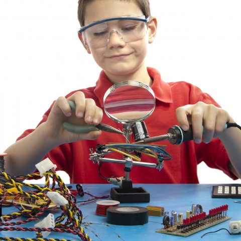 A Small Boy Experimenting with Science Equipment and Enjoying Learning