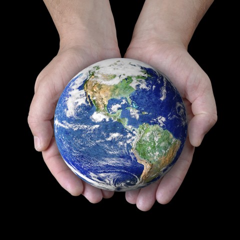 Hands Holding a Small Globe