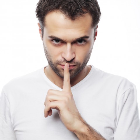 Young Man with His Forefinger in Front of His Mouth, Indicating: Keep Quiet