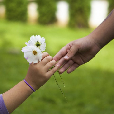 Child Giving Flowers to Their Mother