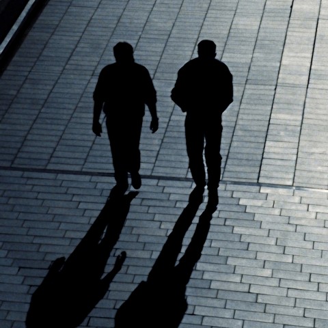 Two People Walking in the Dark, Casting Shadows