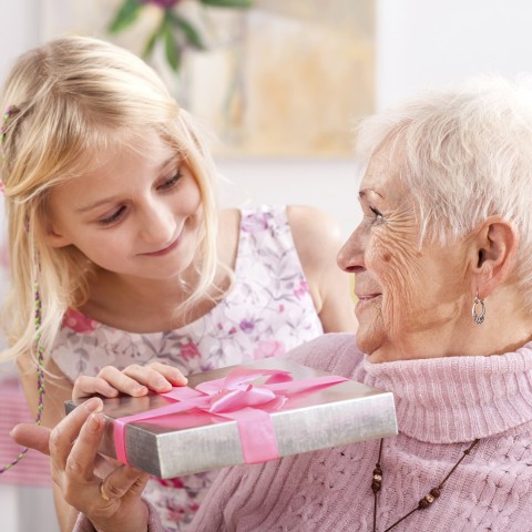 A Girl is Giving a Present to Her Babushka