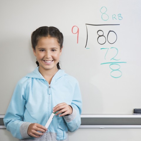 A Girl in Front of a Whiteboard with a Mathematical Calculation 