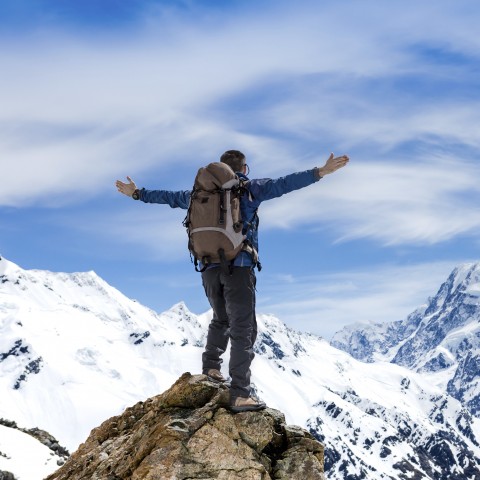 A Man Who Has Reached the Top of a Snowy Mountain