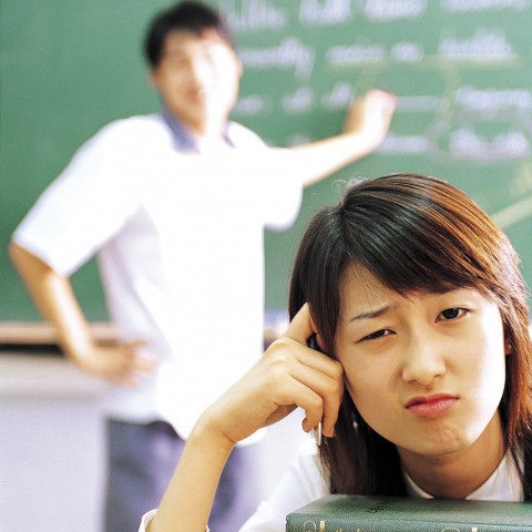 A Student in a Classroom Looking Troubled