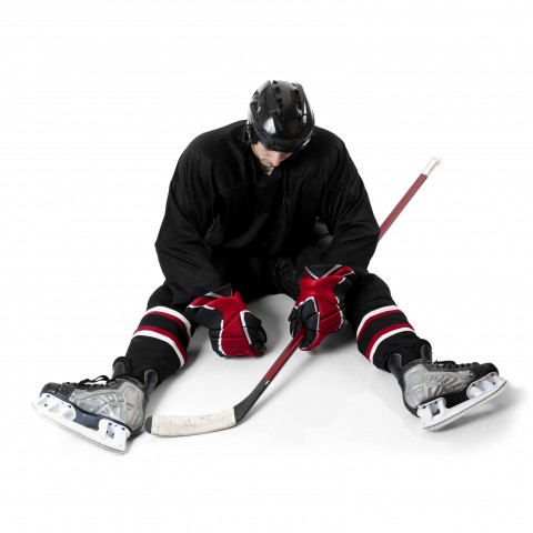 A Hockey Player Sitting on Ice