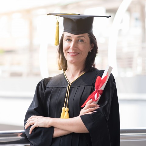 A Woman Wearing a Graduation Cap and Gown