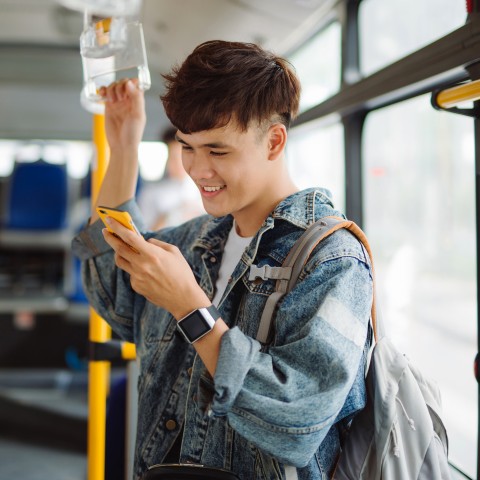 A Man Studying on the Bus