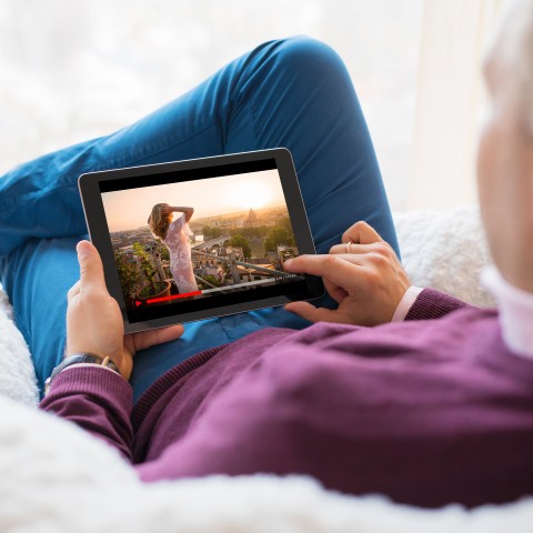 A Man Enjoying a Movie on a Tablet