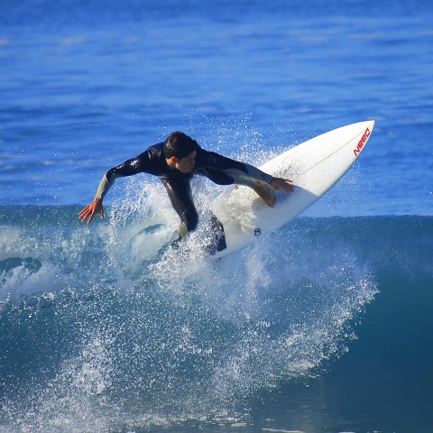 A Man Riding a Wave on a Surfboard