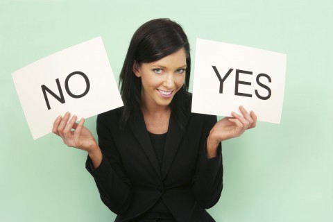 A Woman Holding White Cards with Yes and No on Them