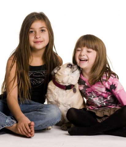 Two Sisters Playing with a Toy in the Jolly Mood