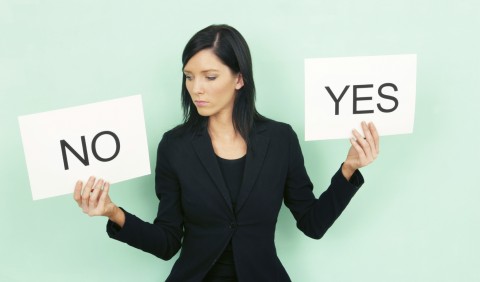 A Woman Holding Cards that Say Yes and No