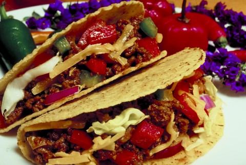 A Plate of Hardshell Tacos with Peppers