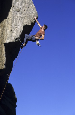 A Man Climbing a Steep Mountain, Symbolizing a High Level of Motivation