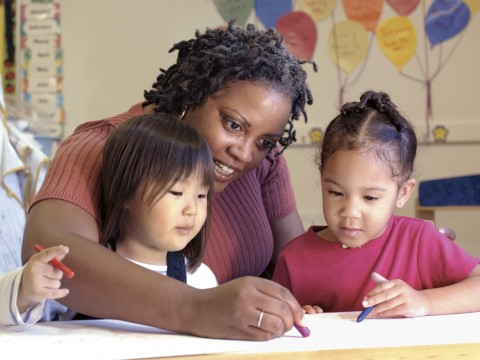 Teacher Teaching Two Toddlers in a Classroom