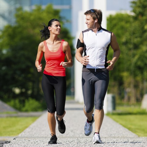 A Man and Woman Jogging Together Outside