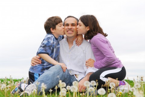 A Father and His Two Children in a Field