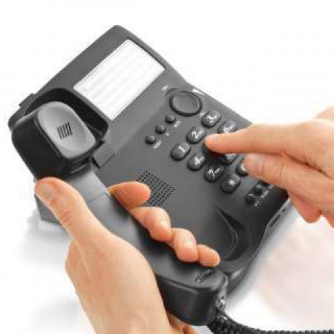 A Person Dialing a Number to Make a Phone Call 