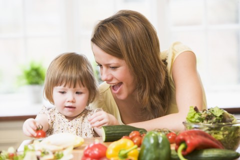 A Baby and a Mother with Vegetables