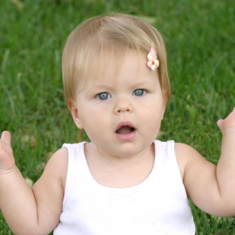 A Little Girl Raising Her Arms with Open Mouth