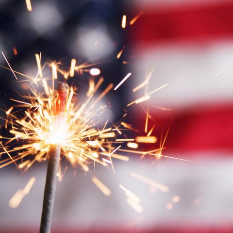 Sparkler in front of U.S. flag