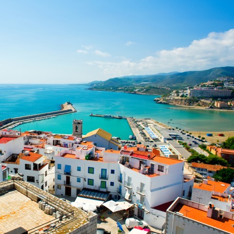 Coastal view of Valencia, Spain, with white buildings and a harbor