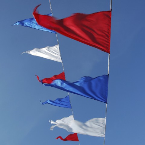 A String of Flags in the Air with the Colors of the Dutch Flag