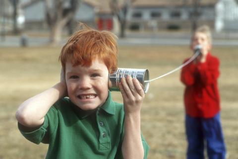 Two Kids Talking through Tin Can Phones