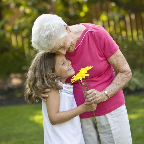 Grandmother Embracing Granddaughter in Field